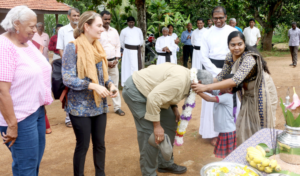 Peace Center staff member, Vinothini, garlands then Presiding Bishop Michael Curry, Sri Lanka, 2019. 